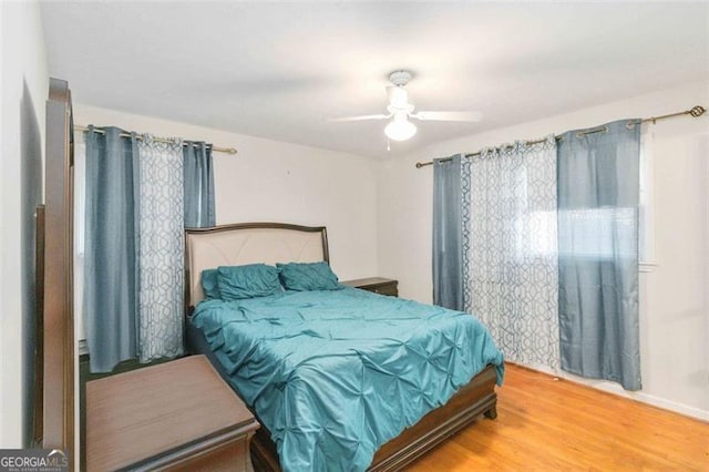 bedroom with wood-type flooring and ceiling fan