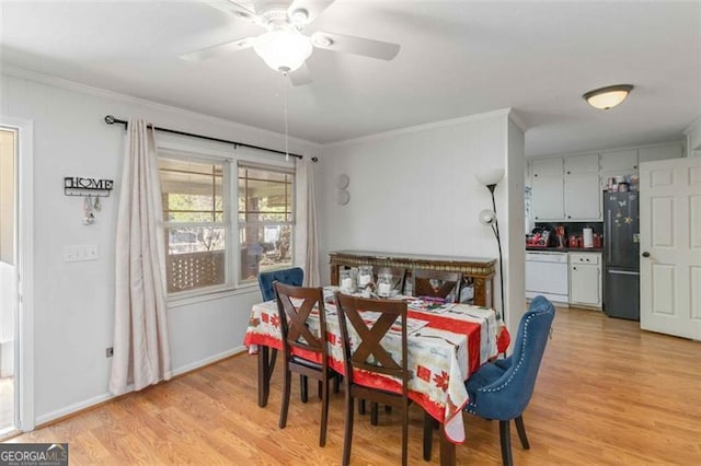 dining room featuring light hardwood / wood-style flooring, ceiling fan, and crown molding