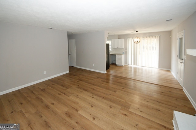 unfurnished living room featuring light hardwood / wood-style flooring