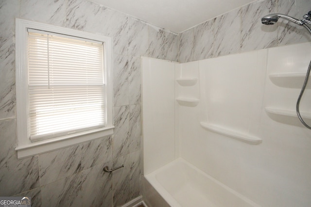 bathroom featuring a wealth of natural light and a shower