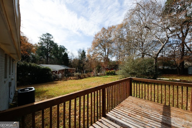 deck with a yard and central AC