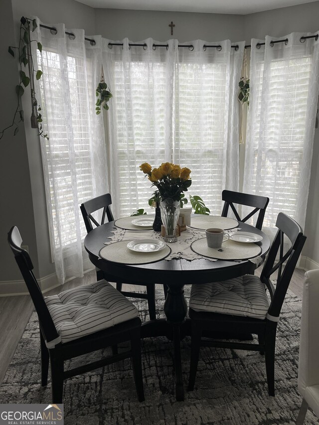 dining room featuring baseboards and wood finished floors