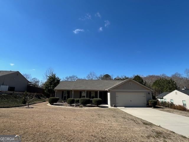 ranch-style home with an attached garage and concrete driveway