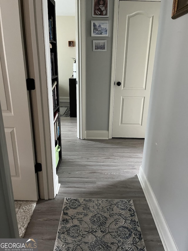 hallway with dark hardwood / wood-style floors