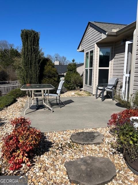 view of patio / terrace featuring fence