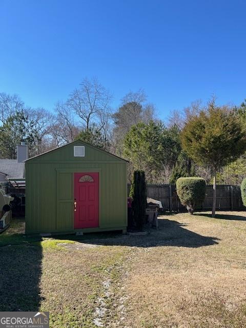 view of shed with fence