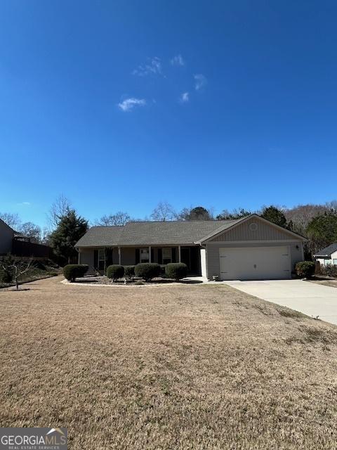 single story home featuring driveway and an attached garage