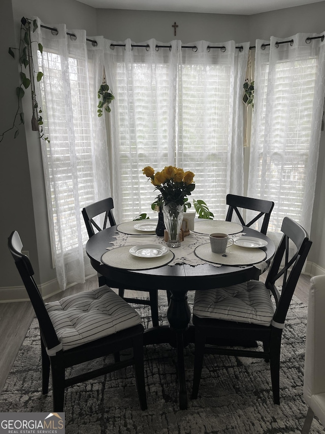 dining area featuring hardwood / wood-style floors and a healthy amount of sunlight