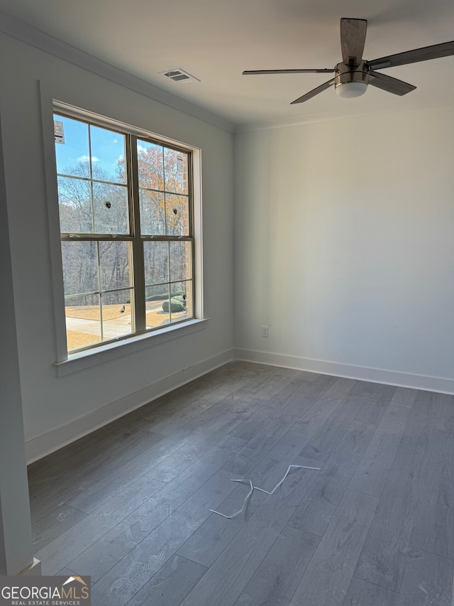 spare room with ceiling fan, ornamental molding, and hardwood / wood-style flooring