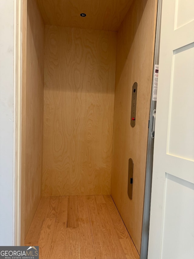 interior space featuring hardwood / wood-style flooring and elevator