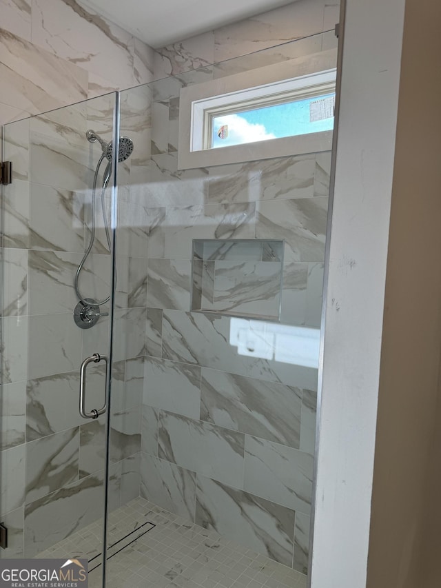 bathroom with a shower with shower door