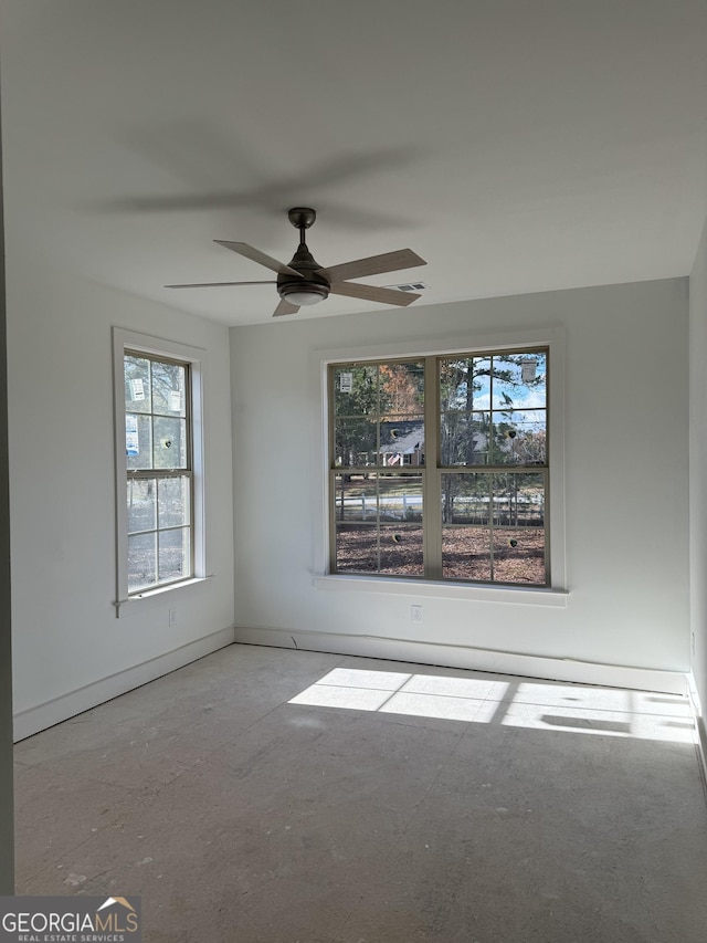 spare room with ceiling fan and a healthy amount of sunlight