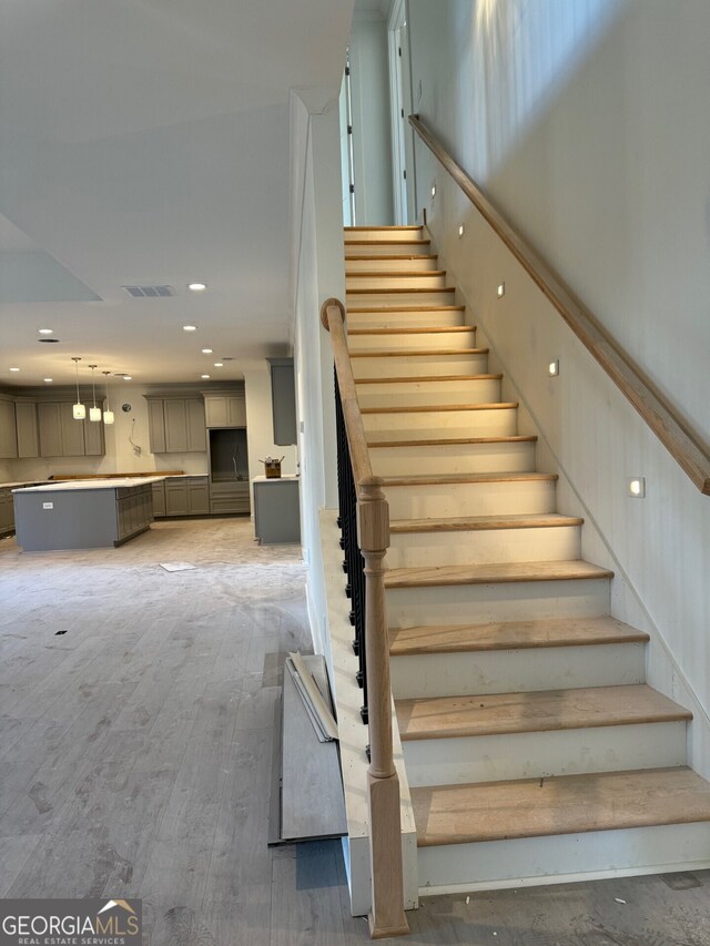 staircase featuring hardwood / wood-style flooring