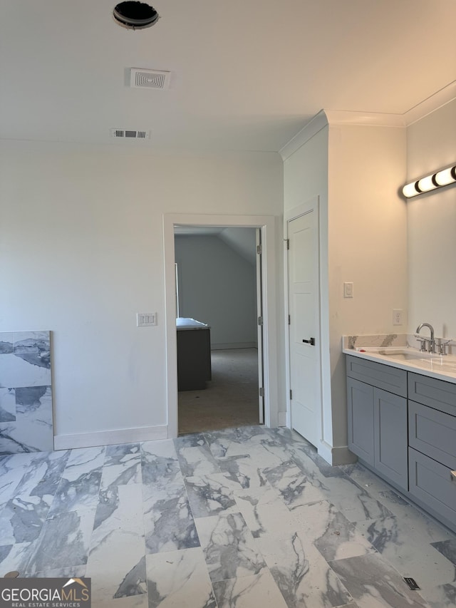 bathroom with vanity and crown molding