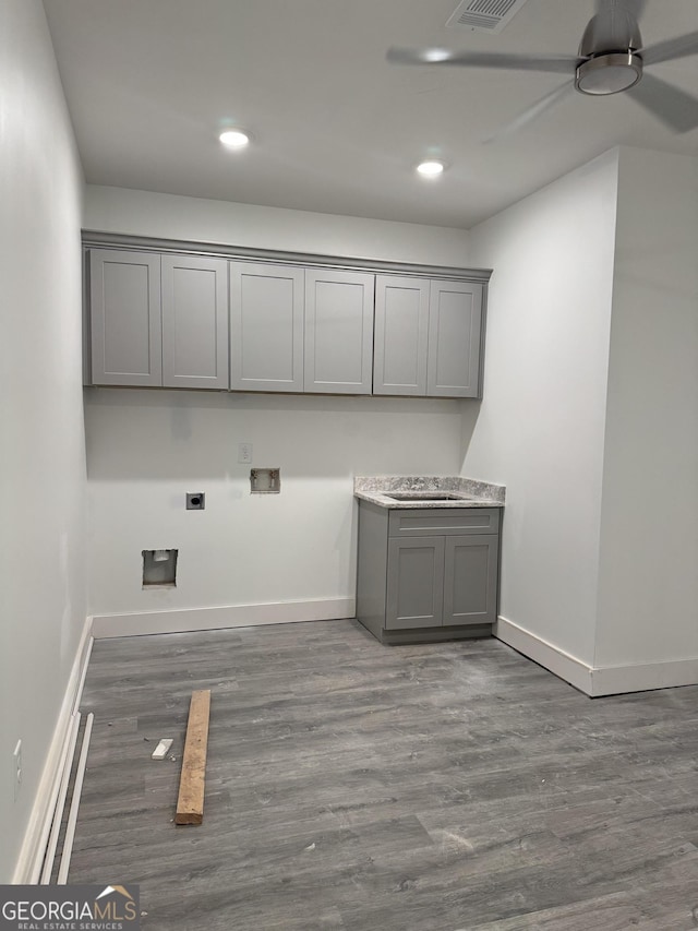 laundry area with sink, cabinets, washer hookup, hookup for an electric dryer, and dark hardwood / wood-style flooring