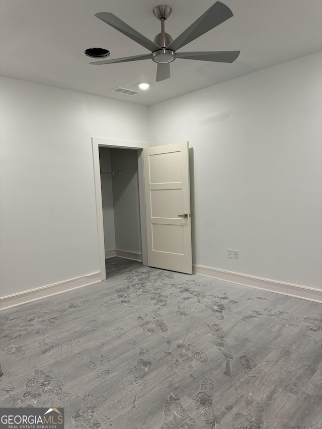 spare room with wood-type flooring and ceiling fan