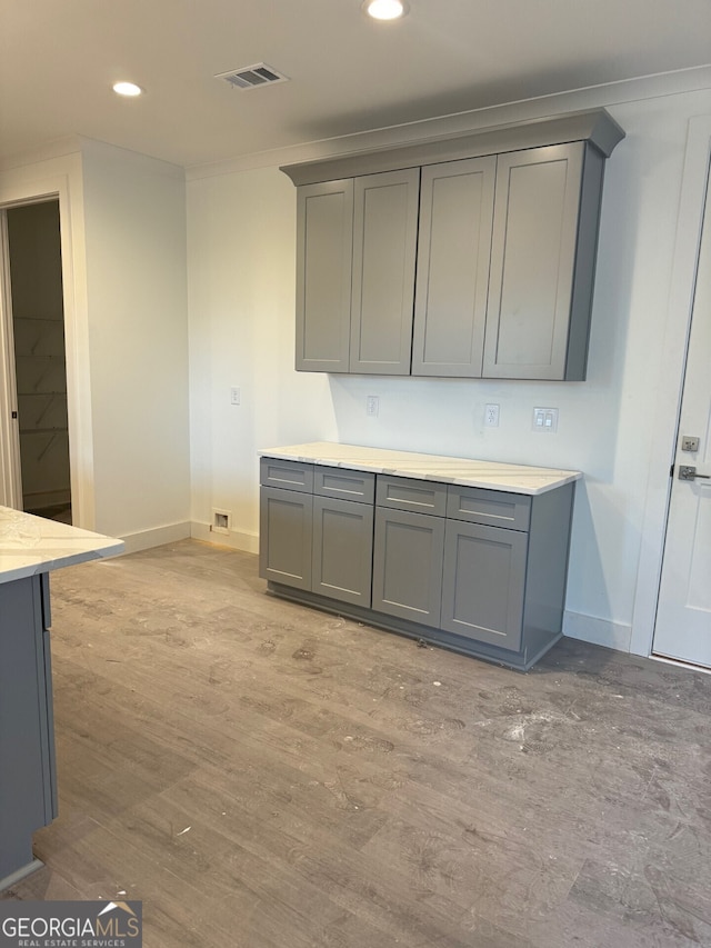 kitchen with gray cabinetry and light wood-type flooring