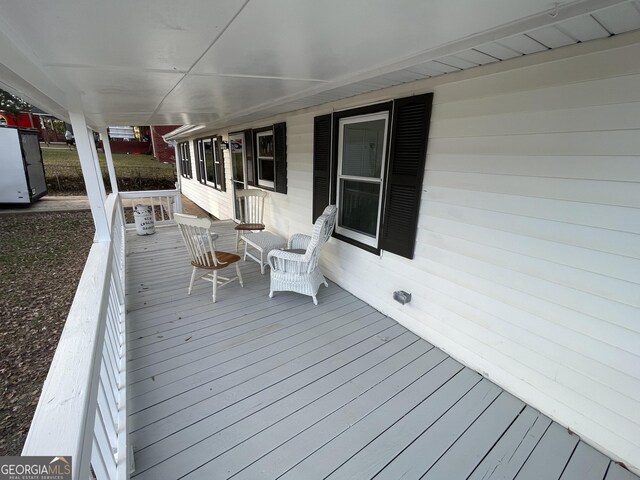 wooden terrace featuring a porch