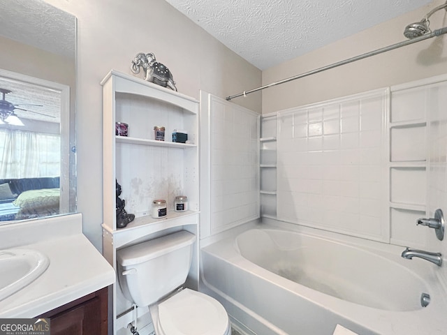 full bathroom featuring vanity, a textured ceiling, toilet, and shower / washtub combination