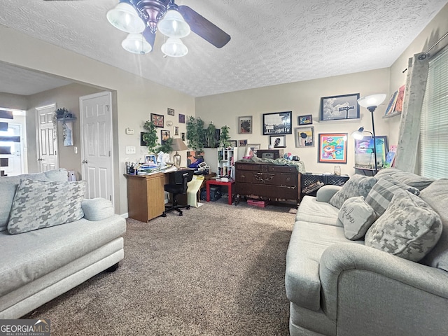 living room featuring carpet, ceiling fan, and a textured ceiling