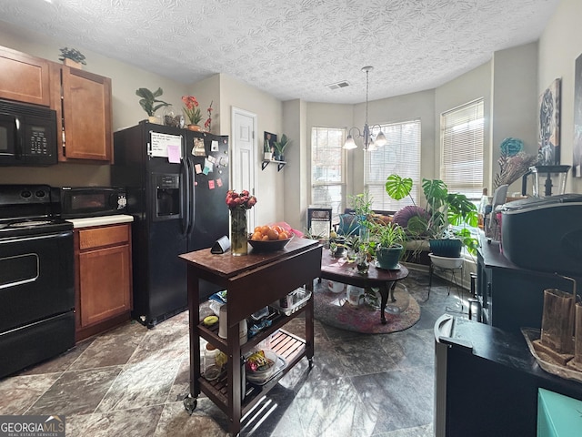 kitchen with a chandelier, hanging light fixtures, black appliances, and a textured ceiling