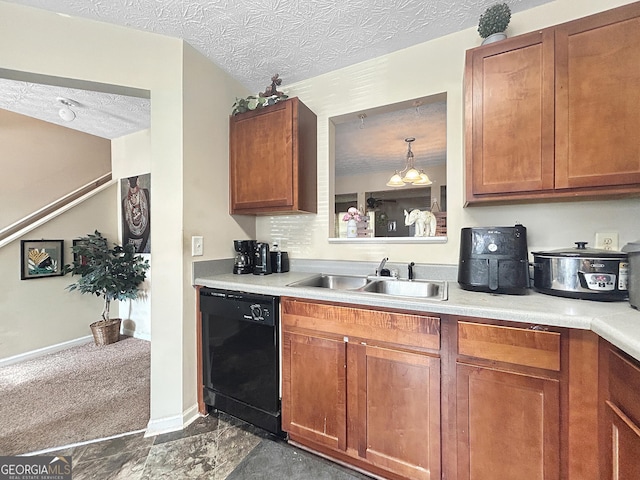 kitchen with a textured ceiling, sink, a notable chandelier, black dishwasher, and hanging light fixtures