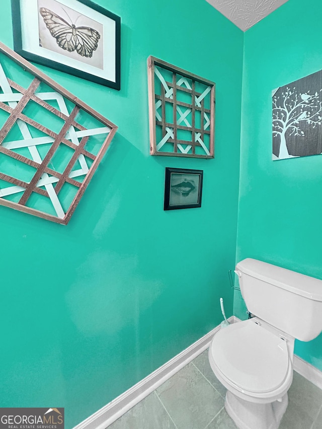 bathroom with tile patterned floors and toilet