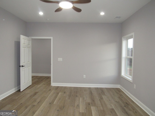 spare room featuring ceiling fan, plenty of natural light, and light hardwood / wood-style flooring