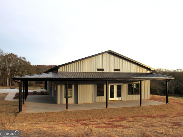 view of front of home with french doors and a patio