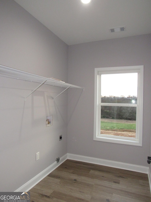 clothes washing area featuring hardwood / wood-style floors, electric dryer hookup, and hookup for a washing machine