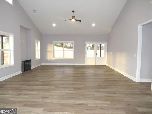 unfurnished living room with french doors, a healthy amount of sunlight, and light wood-type flooring