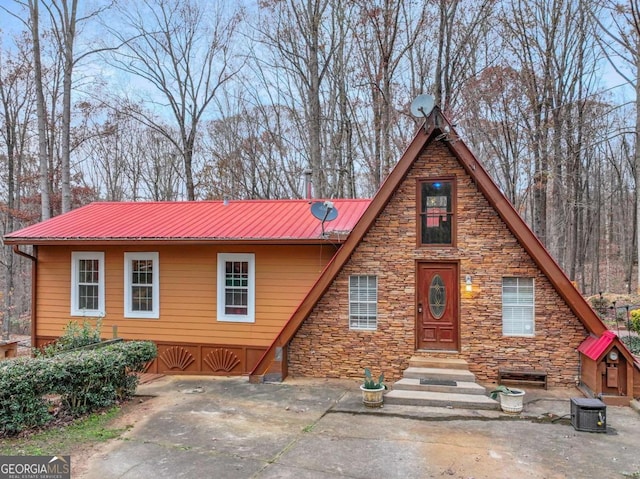 view of front of house featuring central AC and a patio area