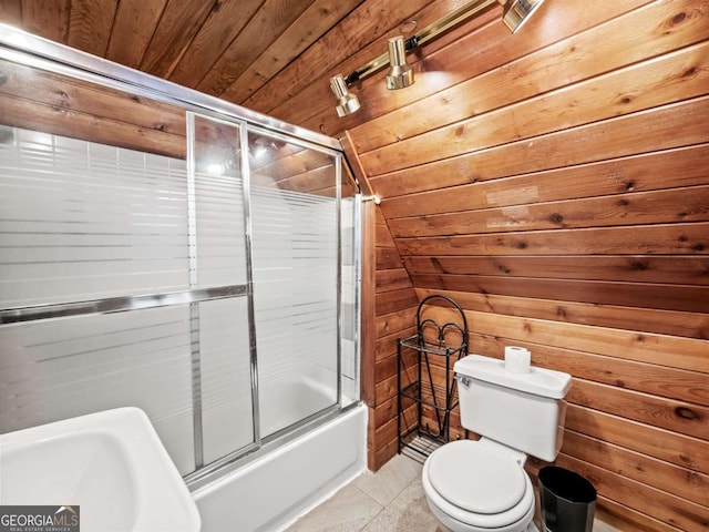 bathroom with toilet, combined bath / shower with glass door, vaulted ceiling, wooden ceiling, and wooden walls