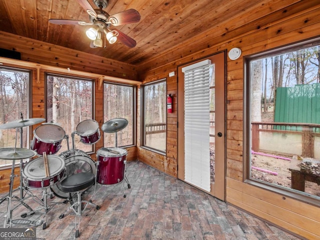 sunroom featuring ceiling fan and wooden ceiling