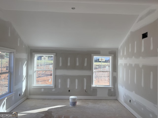 spare room with baseboards and a wealth of natural light