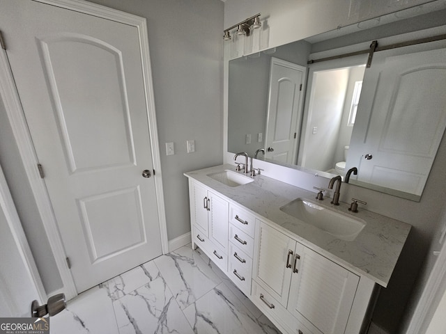 bathroom featuring vanity and toilet