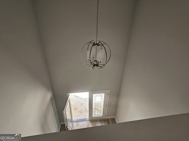 interior details with hardwood / wood-style floors and a notable chandelier