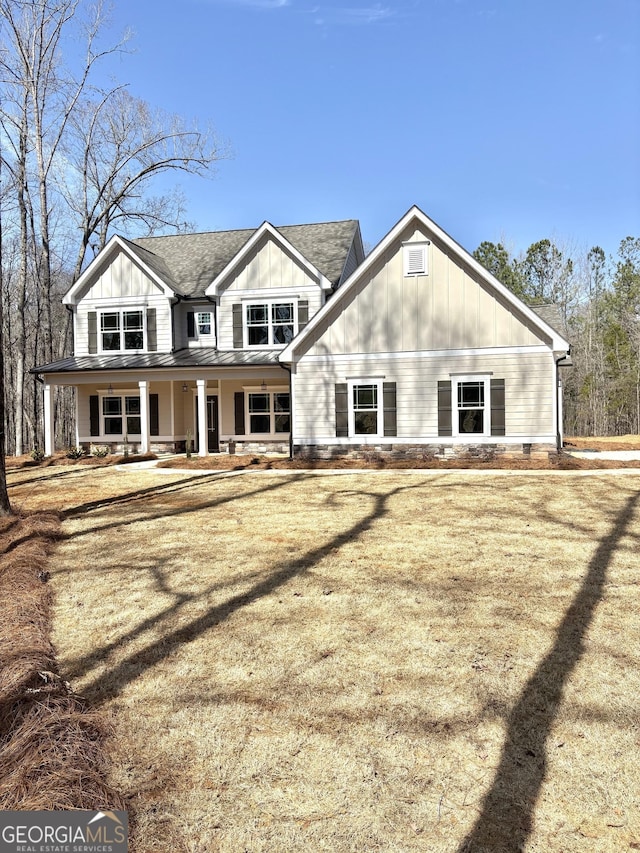 back of house featuring roof with shingles, a porch, and board and batten siding