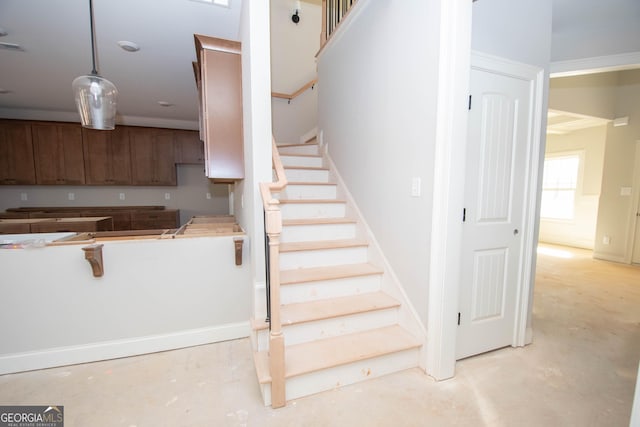 stairway with concrete flooring