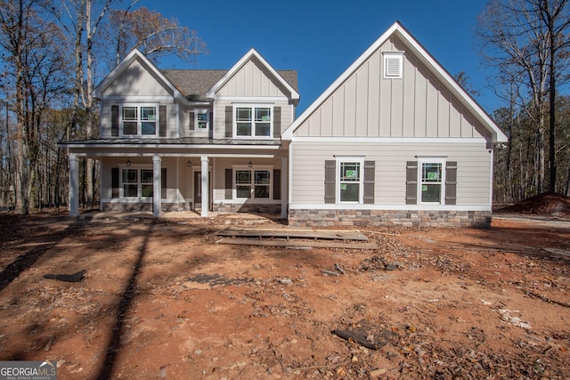 craftsman-style home featuring a porch, board and batten siding, and a shingled roof