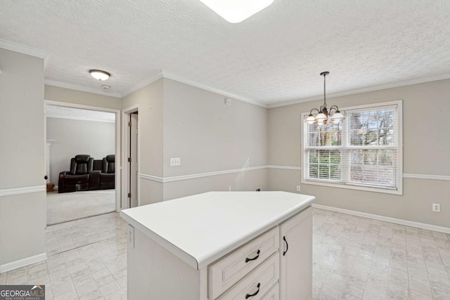 kitchen with a center island, an inviting chandelier, a textured ceiling, decorative light fixtures, and white cabinetry