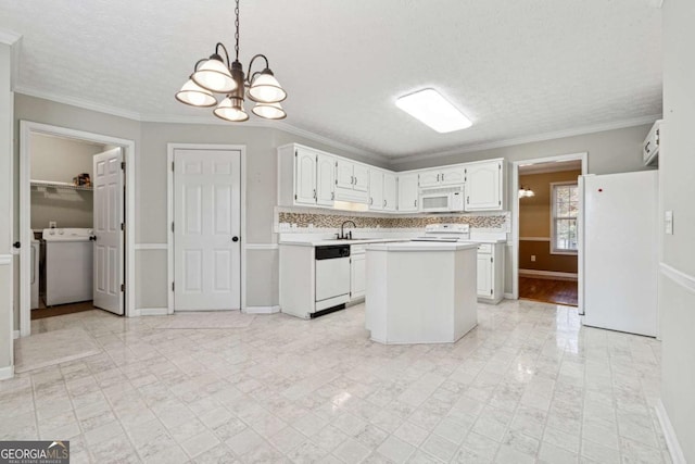 kitchen with white appliances, pendant lighting, white cabinetry, washer / clothes dryer, and a kitchen island