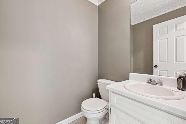 bathroom featuring tile patterned flooring, vanity, and toilet