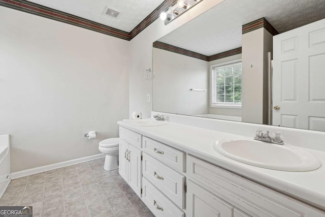 bathroom featuring toilet, vanity, a textured ceiling, and ornamental molding