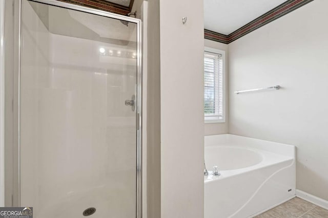 bathroom featuring tile patterned floors and independent shower and bath