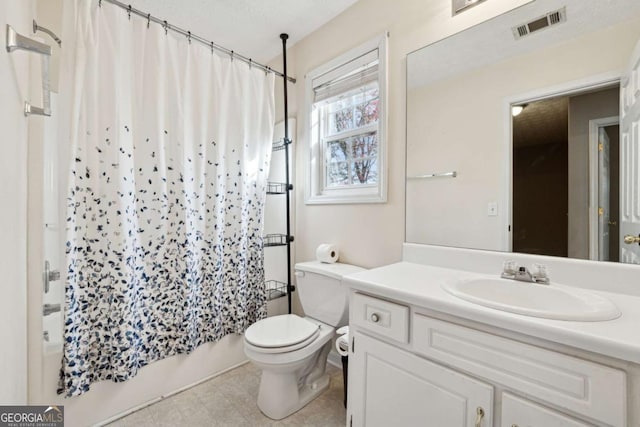 full bathroom with a textured ceiling, vanity, toilet, and shower / bath combo with shower curtain