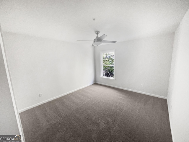 unfurnished room featuring ceiling fan and carpet floors