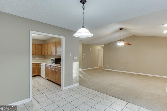 kitchen featuring pendant lighting, lofted ceiling, light carpet, white dishwasher, and ceiling fan