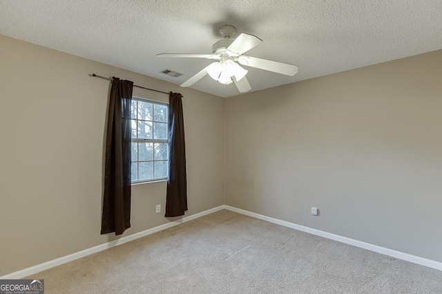 unfurnished room featuring light carpet, a textured ceiling, and ceiling fan