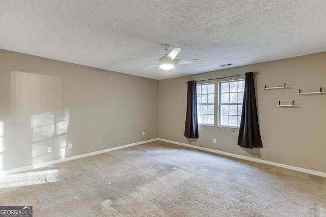 unfurnished room featuring carpet flooring, ceiling fan, and a textured ceiling